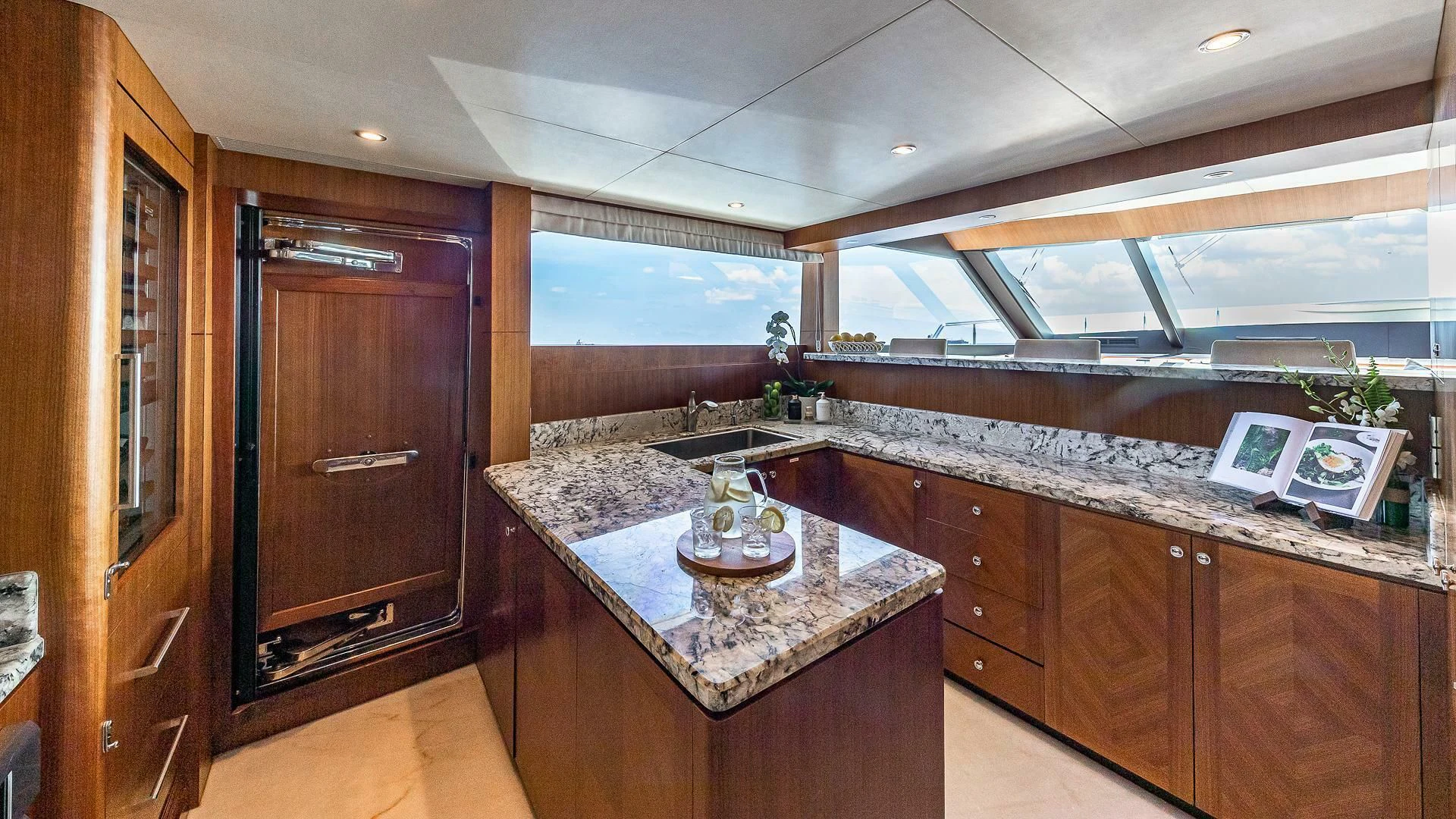 a kitchen with a countertop sink and cabinets aboard BRAVO ZULU II Yacht for Sale