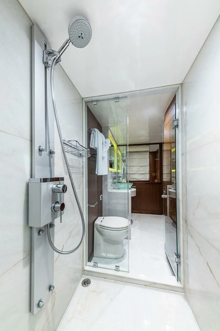 a bathroom with a toilet and shower aboard BRAVO ZULU II Yacht for Sale