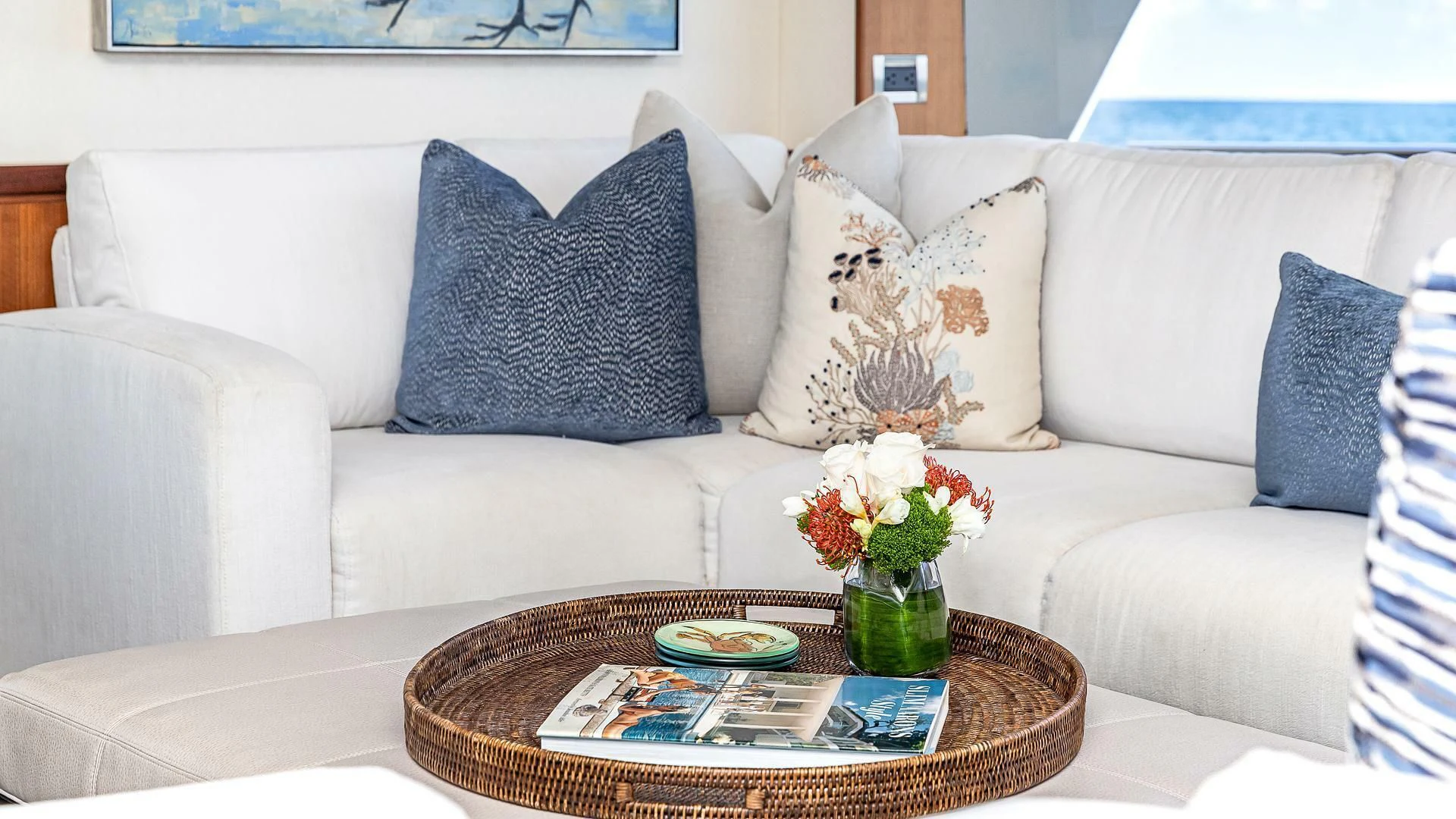 a white couch with pillows and flowers aboard BRAVO ZULU II Yacht for Sale