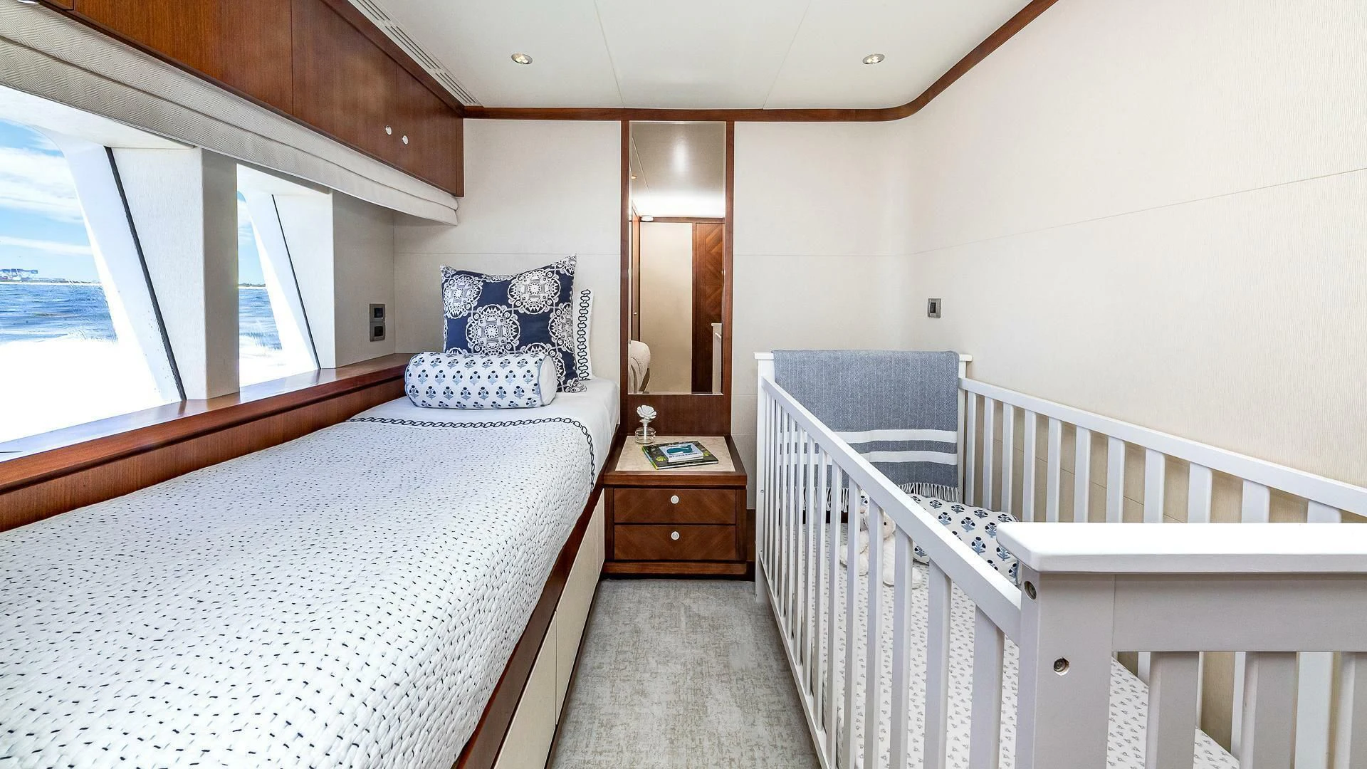 a bedroom with a bed and a mirror aboard BRAVO ZULU II Yacht for Sale