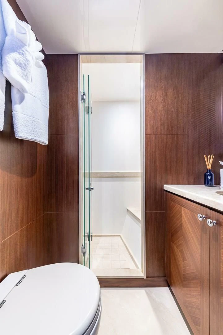 a bathroom with a glass shower aboard BRAVO ZULU II Yacht for Sale