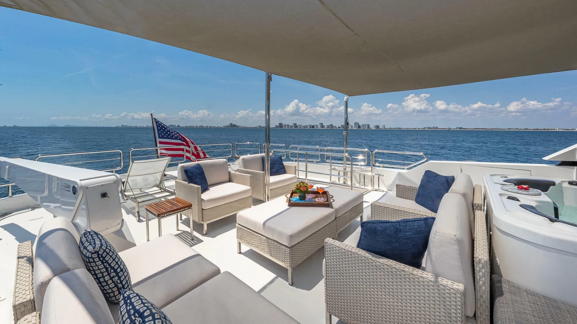 a large white lounge chair on a boat with a large body of water in the background aboard BRAVO ZULU II Yacht for Sale