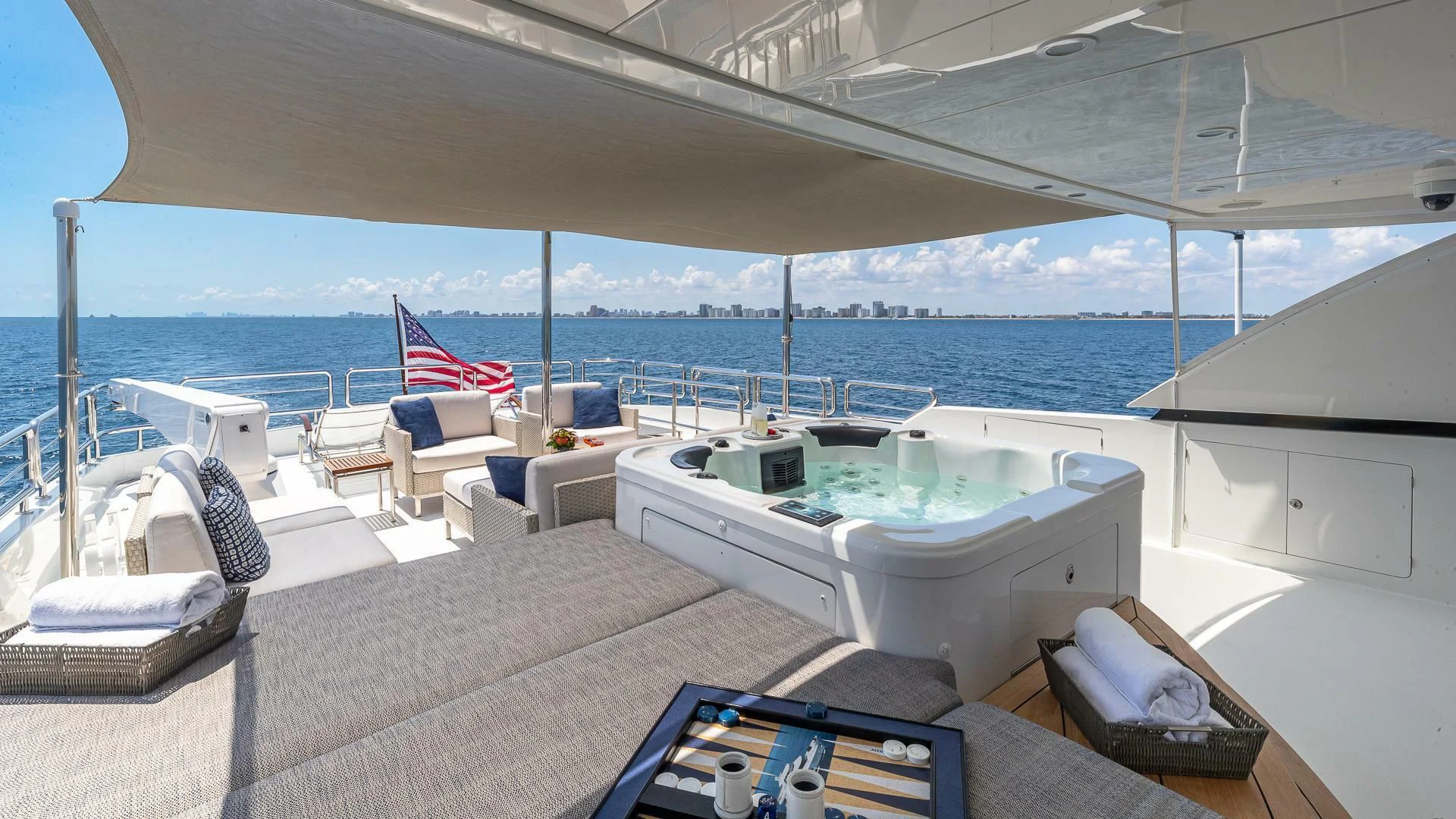 a large white lounge chair next to a large white swimming pool aboard BRAVO ZULU II Yacht for Sale