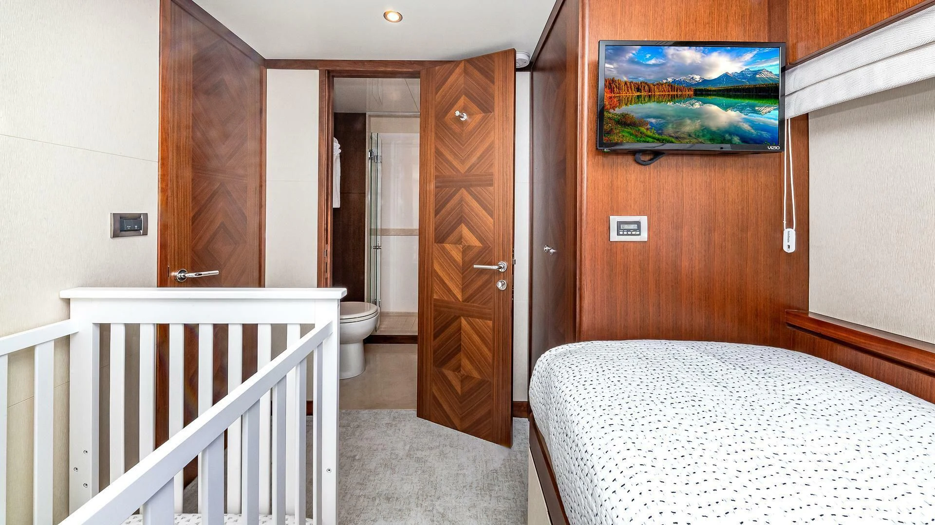 a bed and a door in a room aboard BRAVO ZULU II Yacht for Sale