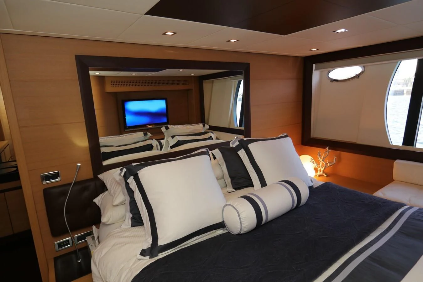 a room with a bed and a tv aboard VANTAGE Yacht for Charter