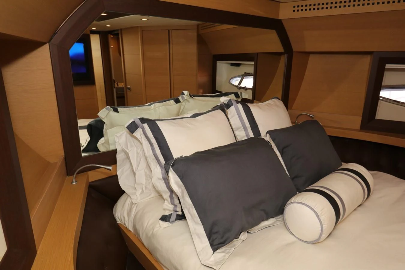 a bed with a blue blanket aboard VANTAGE Yacht for Charter