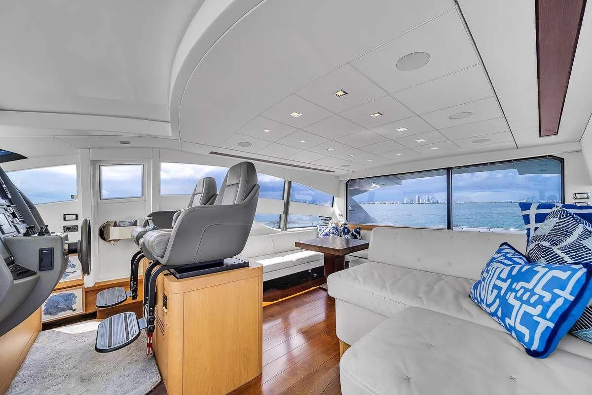 a room with a couch and a television aboard VANTAGE Yacht for Charter