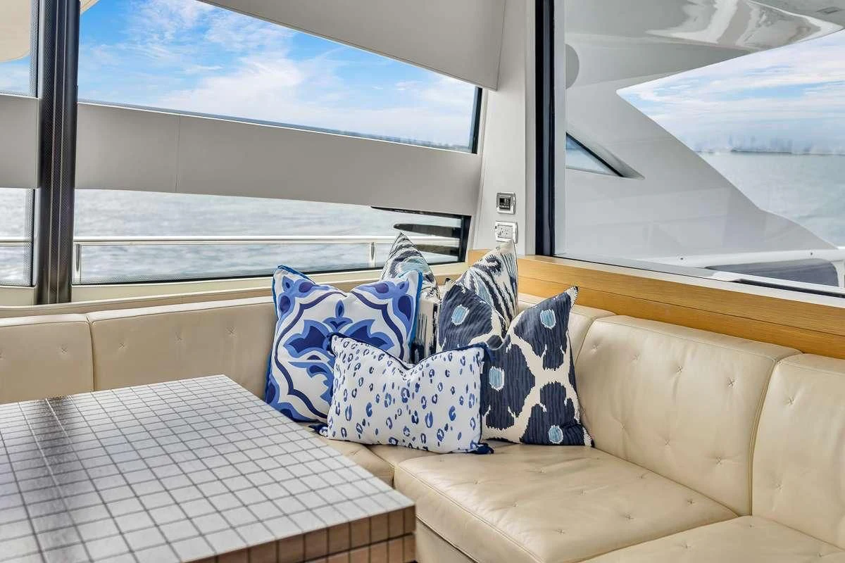 a couch with pillows on it aboard VANTAGE Yacht for Charter