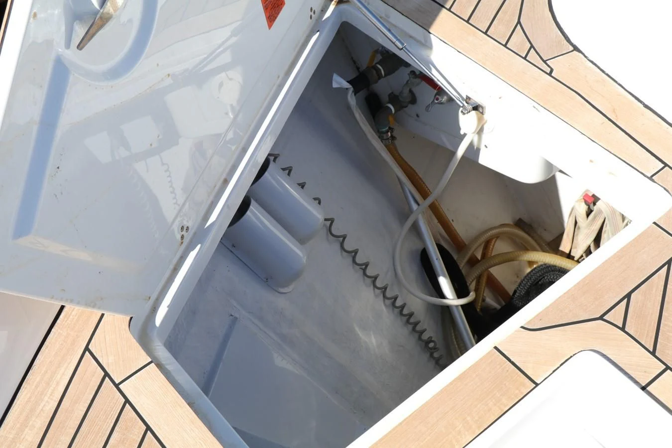 a black and white cat lying on a grey surface aboard VANTAGE Yacht for Charter