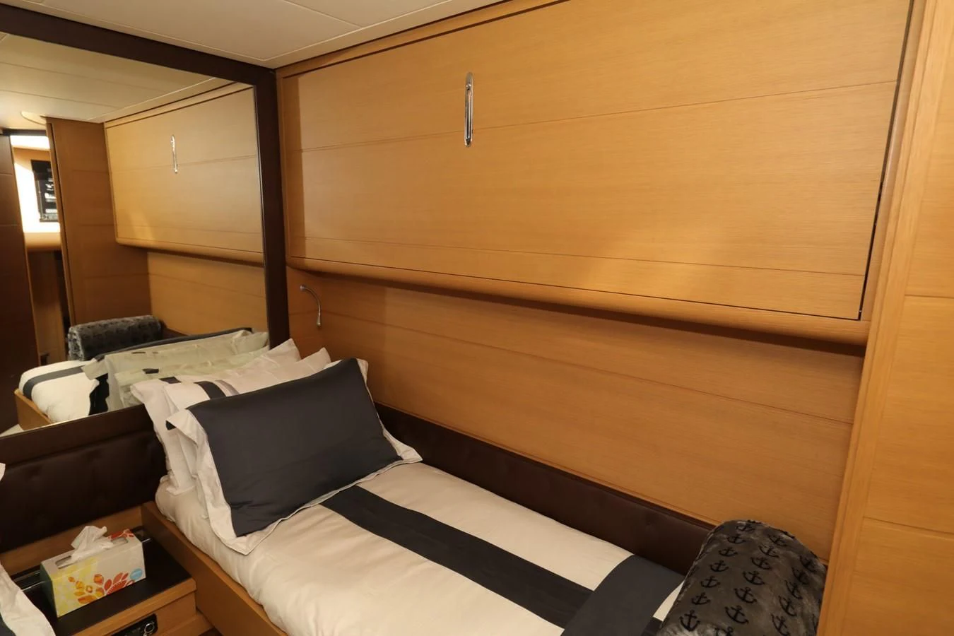 a bed with a wooden headboard aboard VANTAGE Yacht for Charter