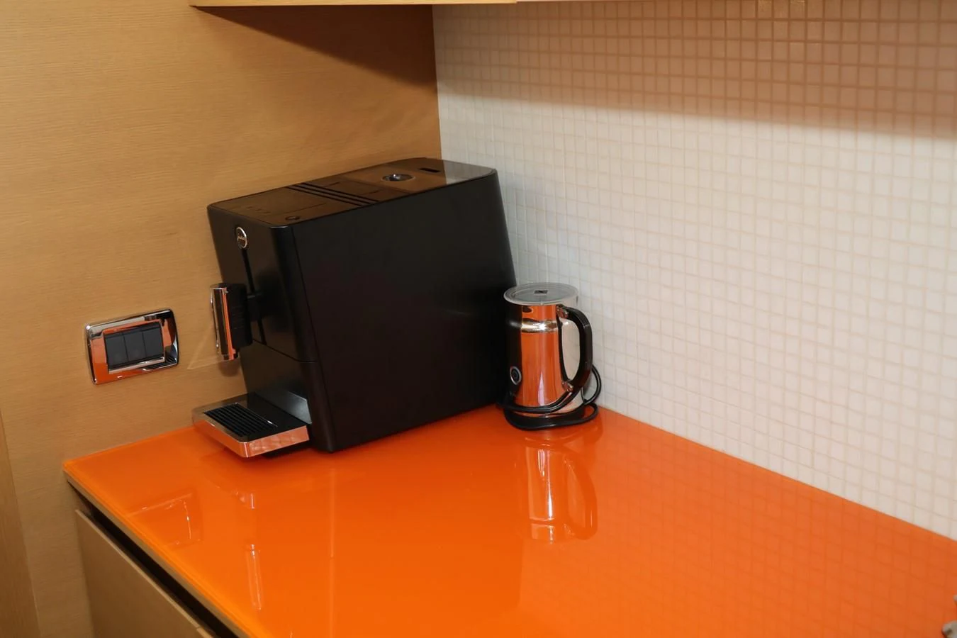 a coffee maker and a phone on a counter aboard VANTAGE Yacht for Charter