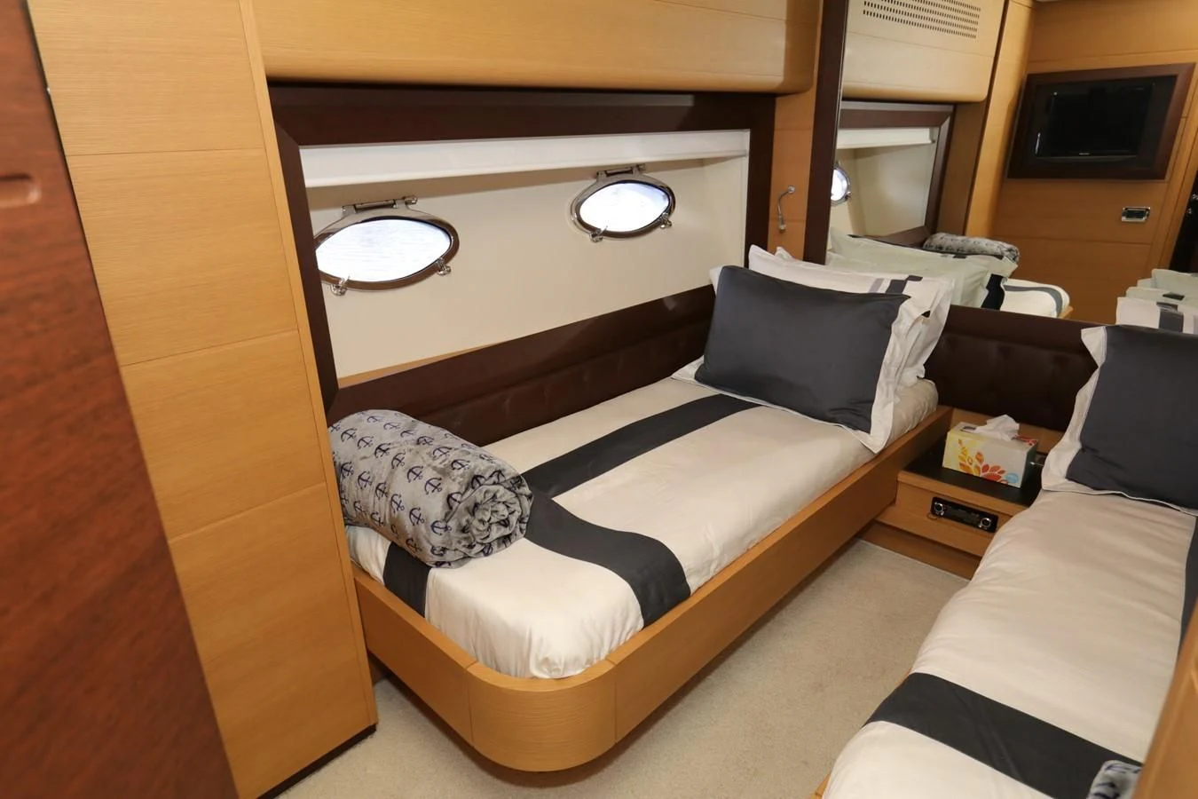 a room with a bed and a mirror aboard VANTAGE Yacht for Charter