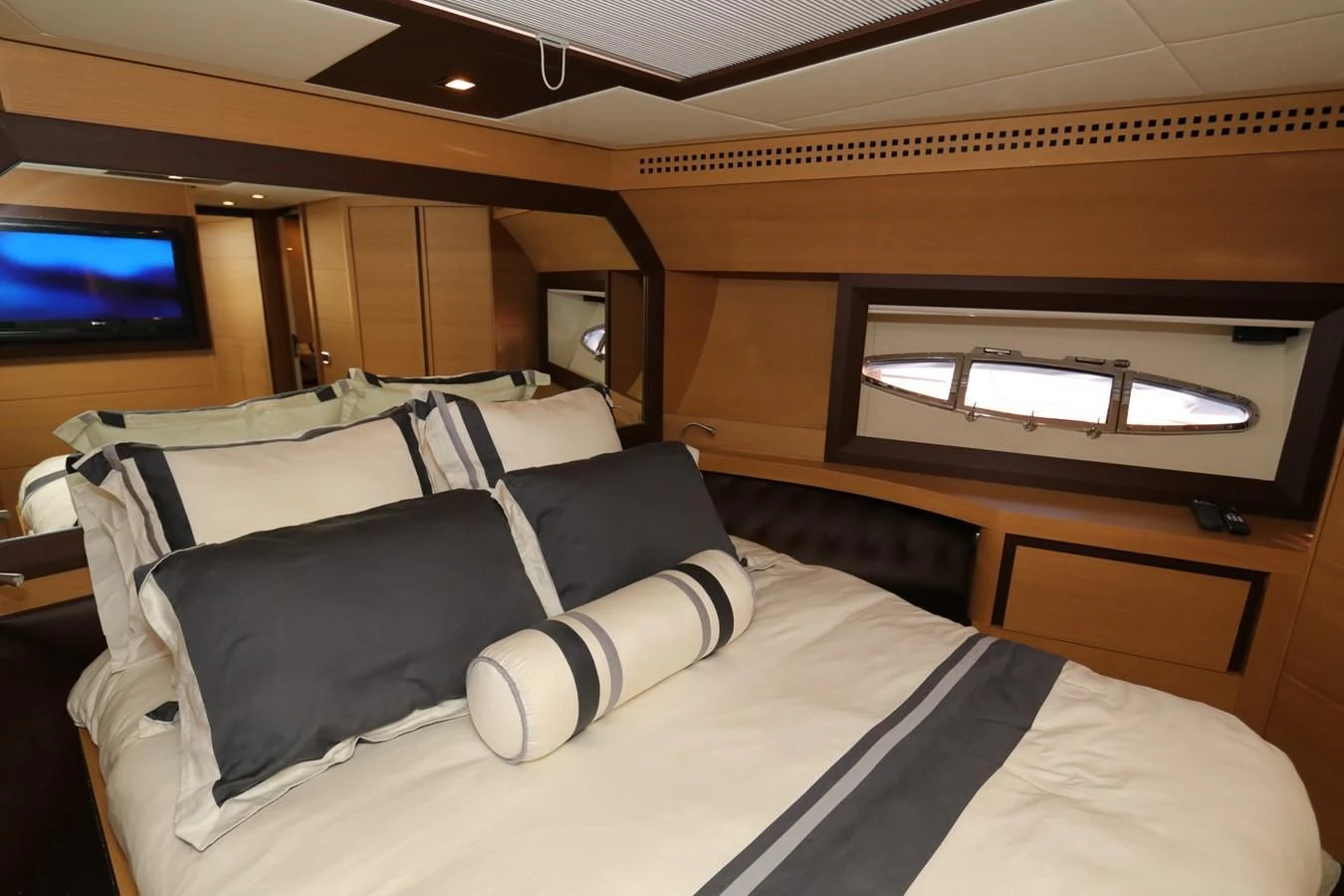 a room with a bed and tv aboard VANTAGE Yacht for Charter