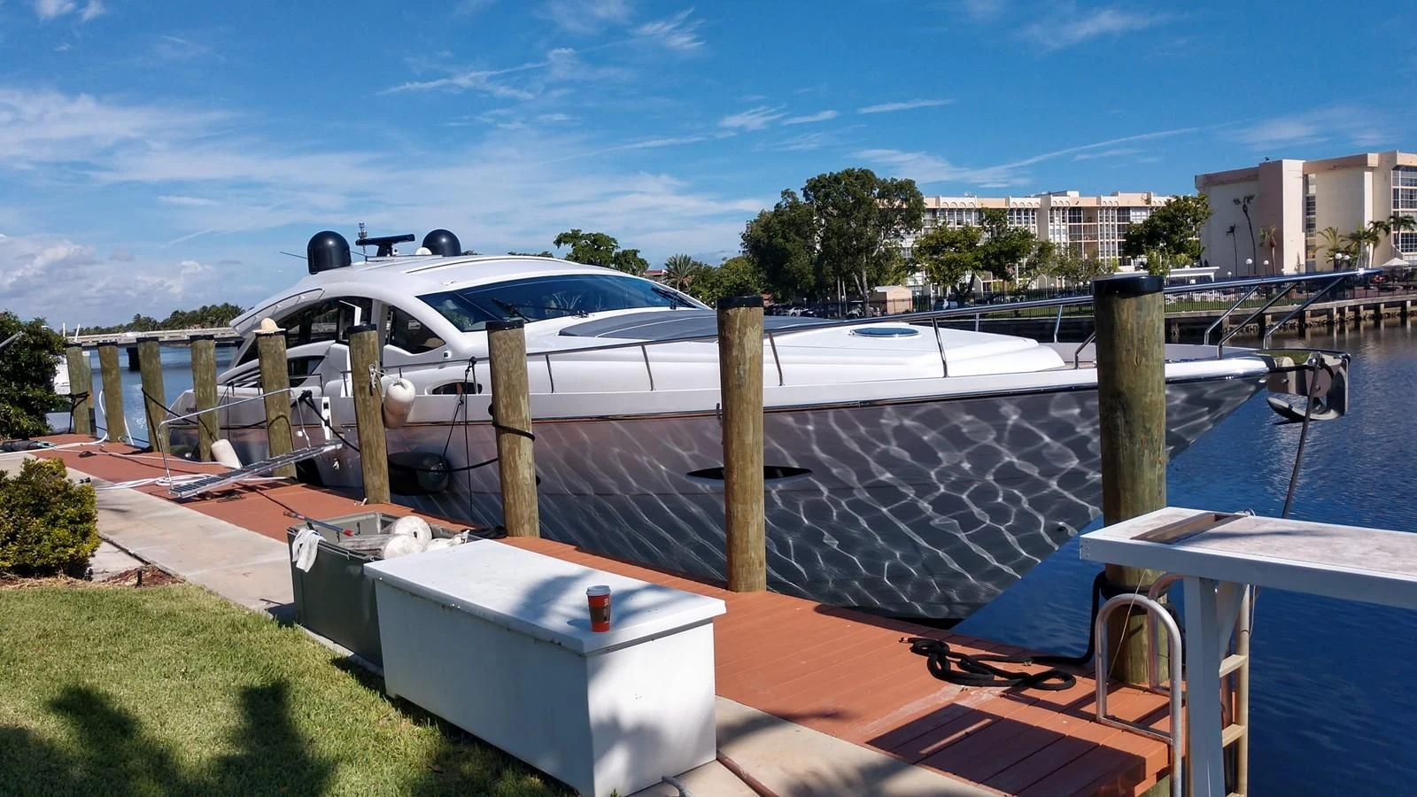a building with a roof and a pool with a pool in the foreground aboard VANTAGE Yacht for Charter