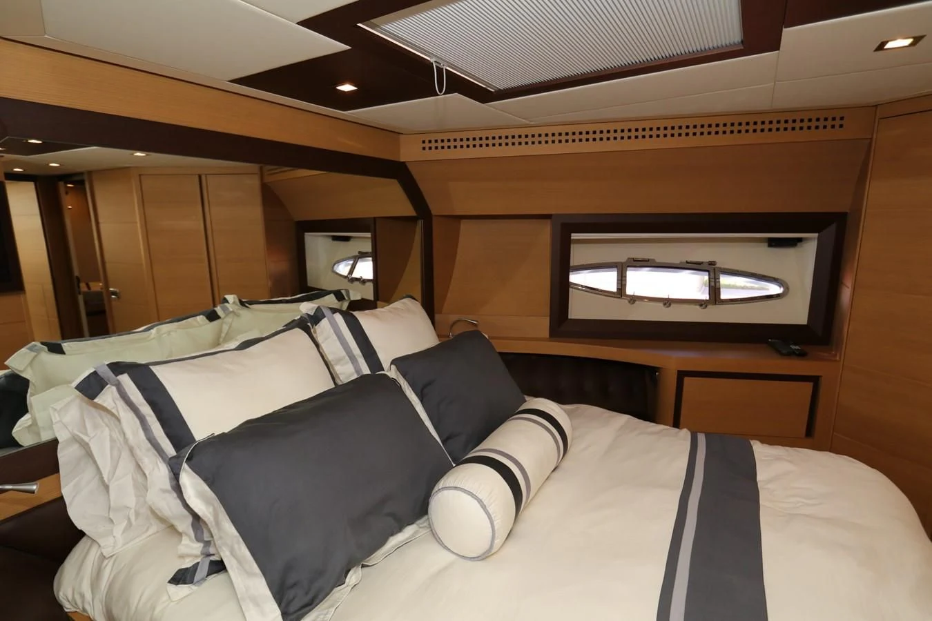 a bed with a television on the wall aboard VANTAGE Yacht for Charter