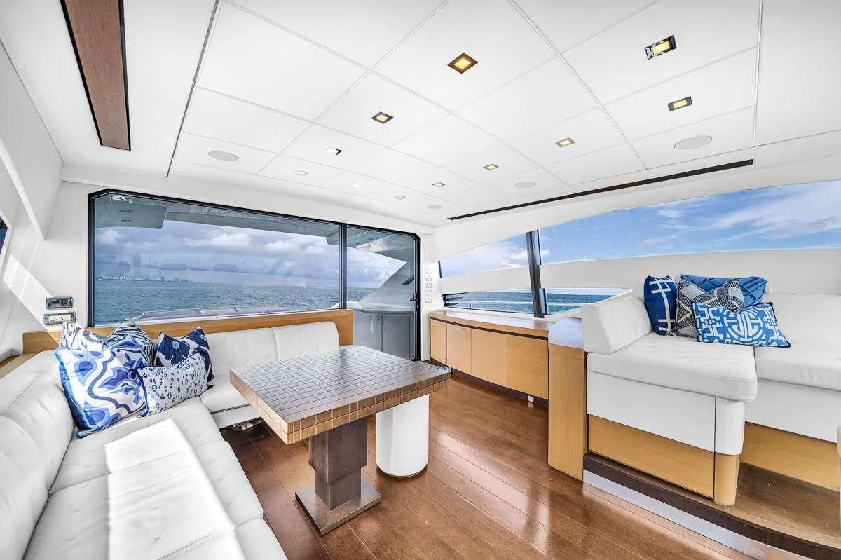 a room with a table and couches aboard VANTAGE Yacht for Charter