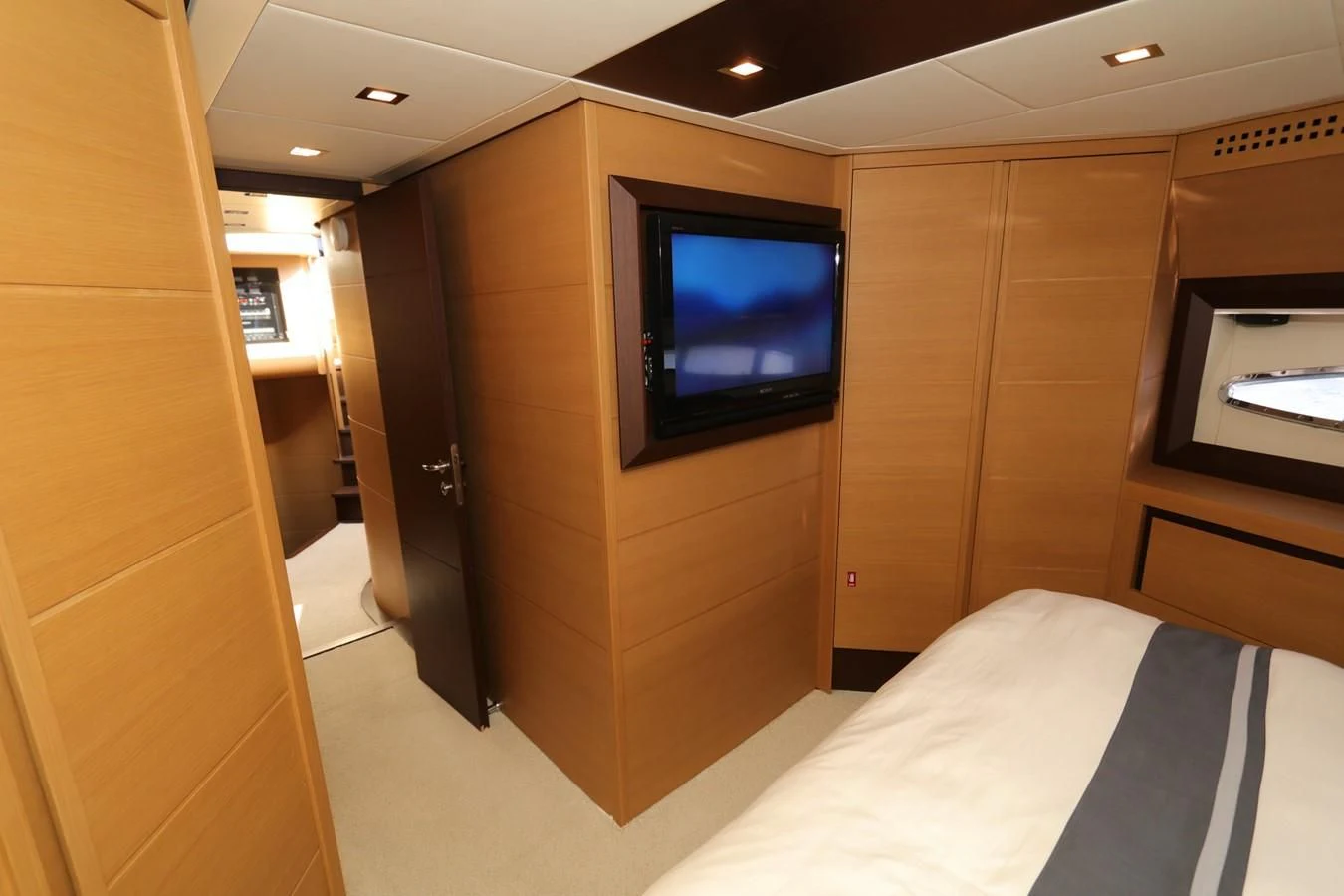 a room with a tv and a bed aboard VANTAGE Yacht for Charter