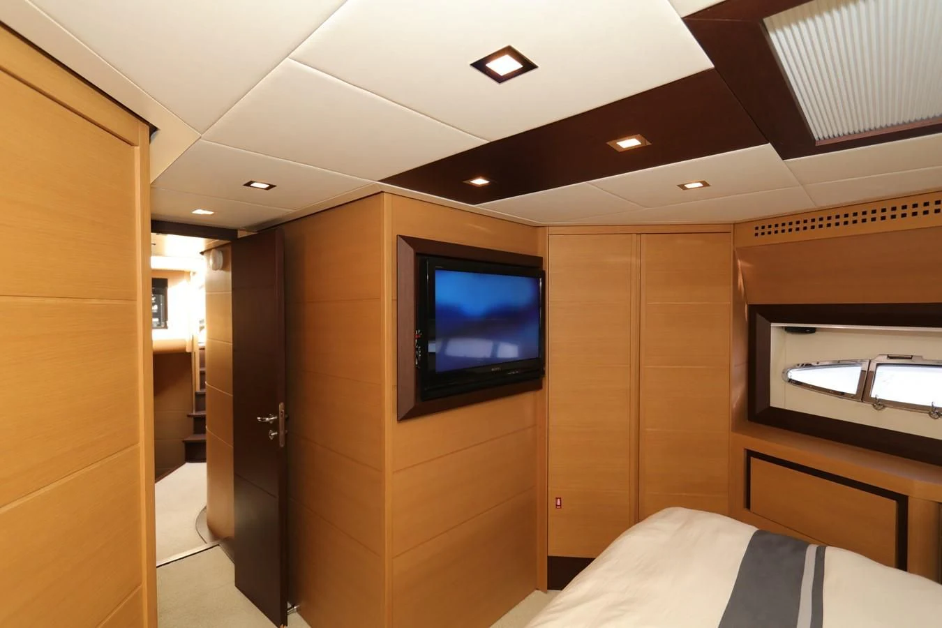 a room with a tv and a bed aboard VANTAGE Yacht for Charter