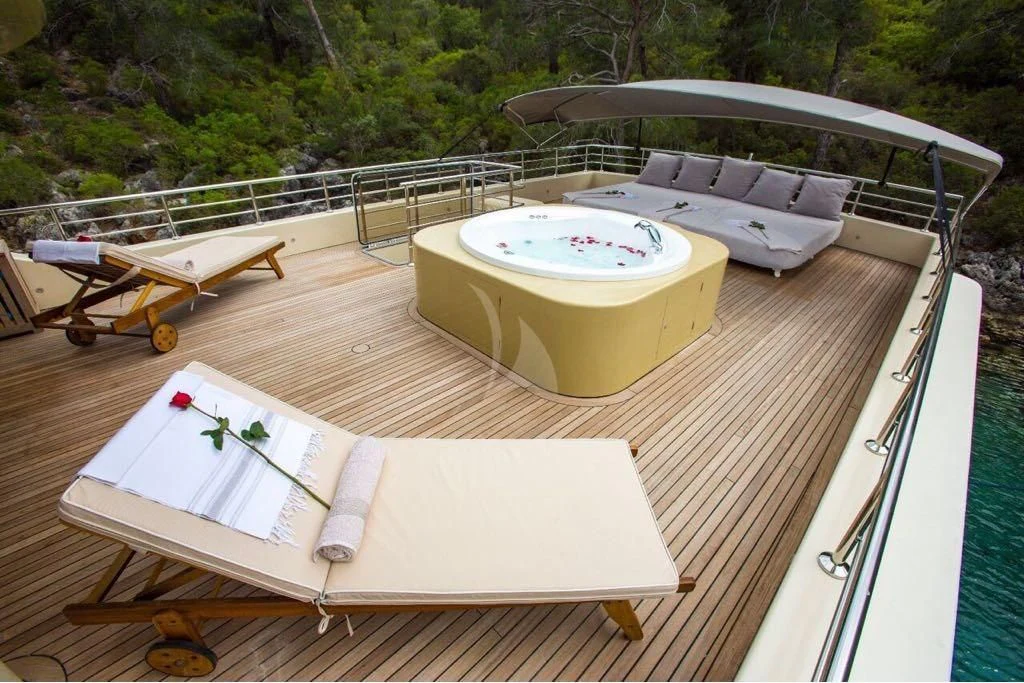 a deck with a pool table and chairs on it aboard SIMAY S Yacht for Sale