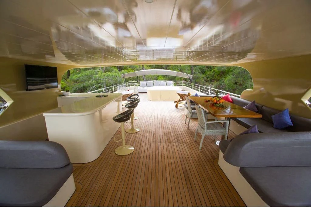 a room with a table chairs and a couch aboard SIMAY S Yacht for Sale