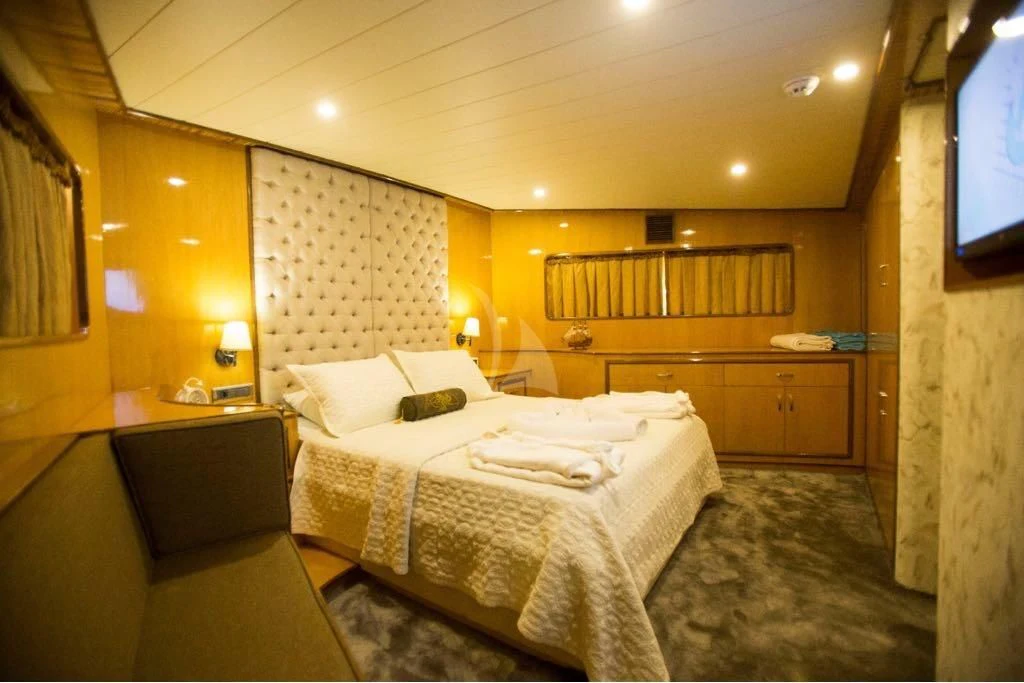 a room with a bed and a tv aboard SIMAY S Yacht for Sale