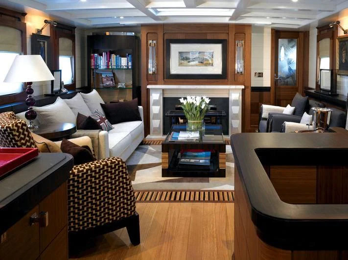 a living room with a fireplace aboard BLUE BIRD OF 1938 Yacht for Sale