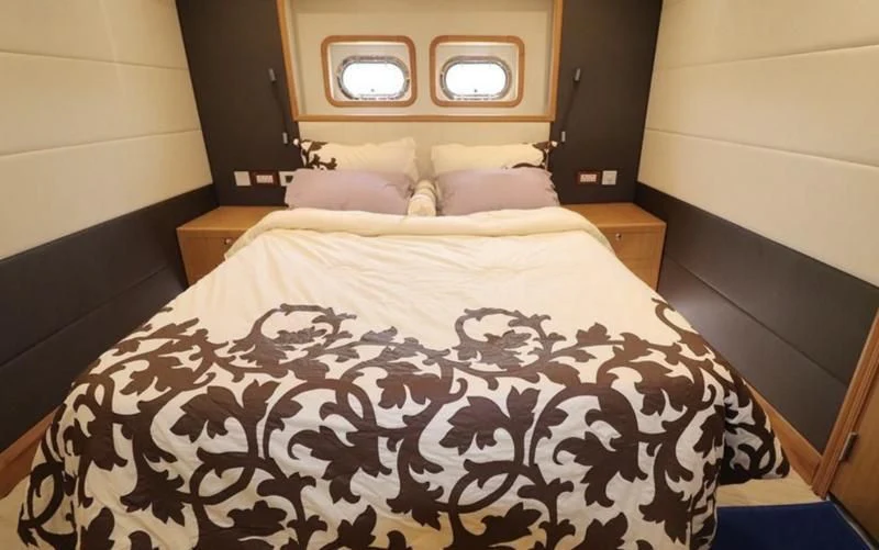 a bed with a black and white comforter and a white bed spread aboard BIN HABIB 1 Yacht for Sale