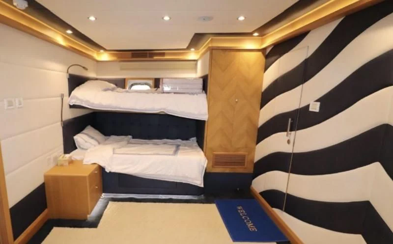 a room with a black and white striped bed and black and white striped bedspread aboard BIN HABIB 1 Yacht for Sale