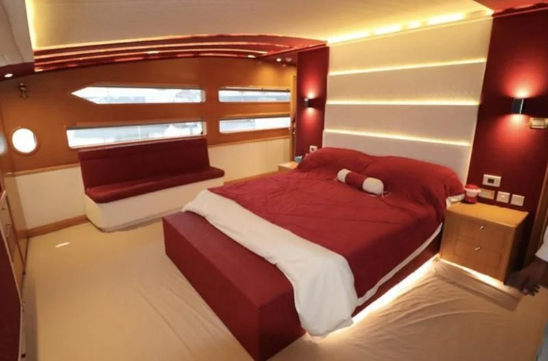 a bed with a red comforter aboard BIN HABIB 1 Yacht for Sale