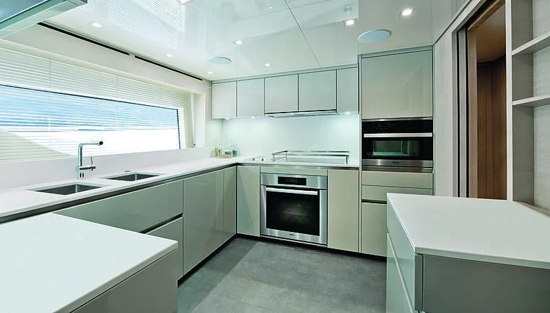 a kitchen with white cabinets aboard RUSCELLO Yacht for Sale