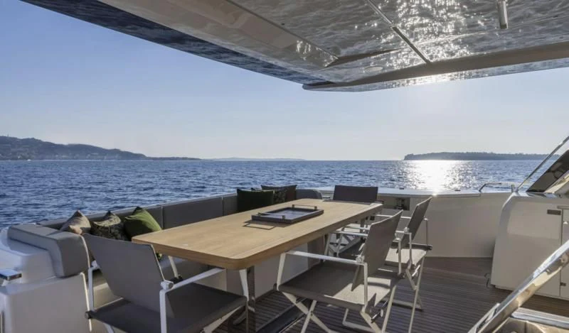 a table and chairs on a boat aboard FERRETTI 780/41 Yacht for Sale