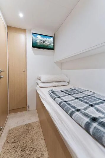 a small bedroom with a tv on the wall aboard FERRETTI 780/41 Yacht for Sale