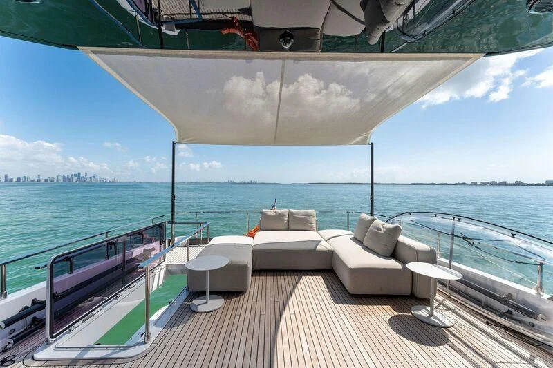 a deck with chairs on it by the water aboard FERRETTI 780/41 Yacht for Sale