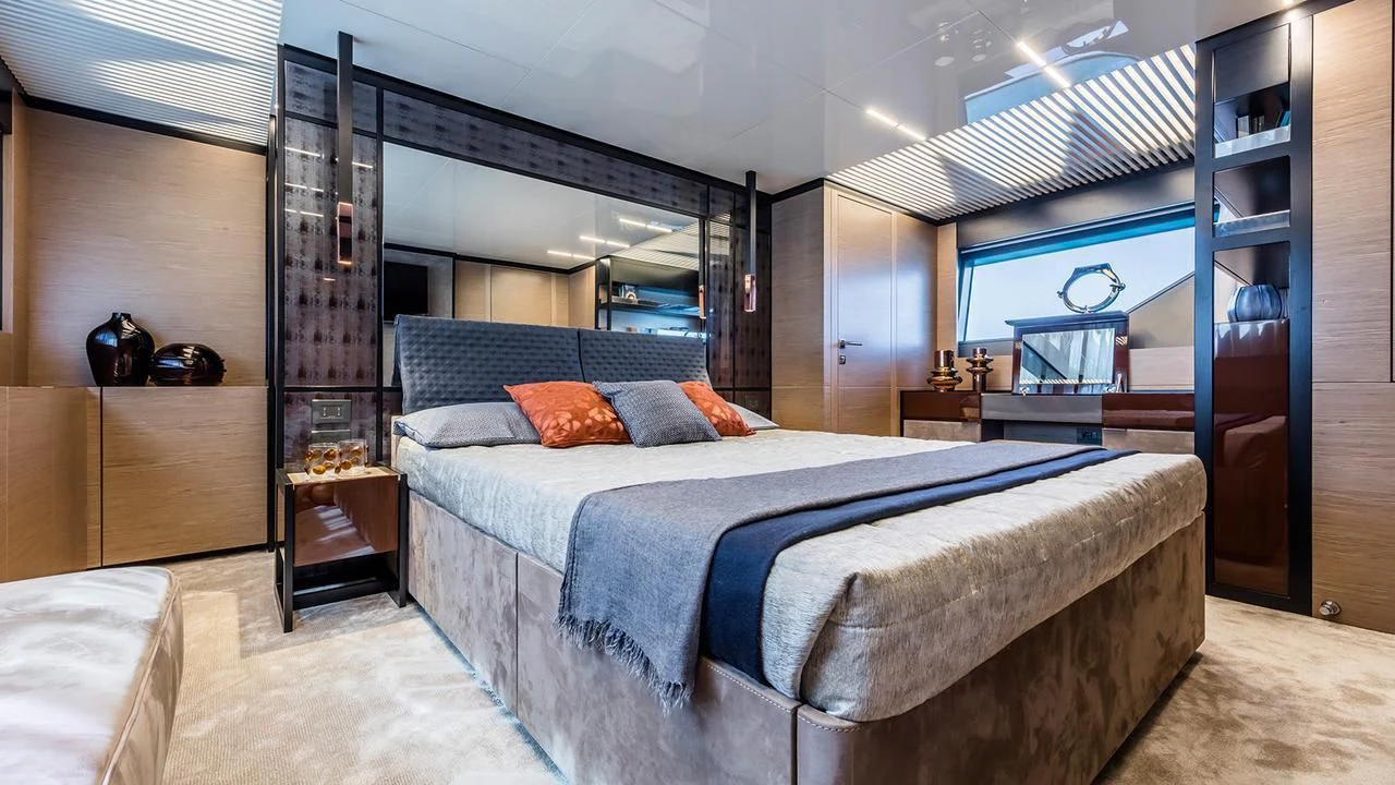 a bedroom with a bed and a bookcase aboard FERRETTI 780/41 Yacht for Sale