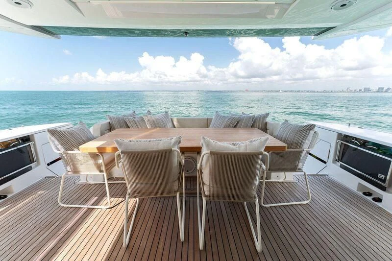a deck with chairs and tables on it aboard FERRETTI 780/41 Yacht for Sale
