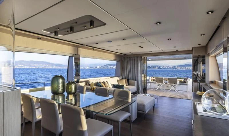 a large living room with a large window overlooking the ocean aboard FERRETTI 780/41 Yacht for Sale