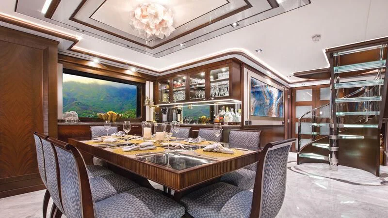 a large dining table in a room aboard VIVIERAE II Yacht for Sale