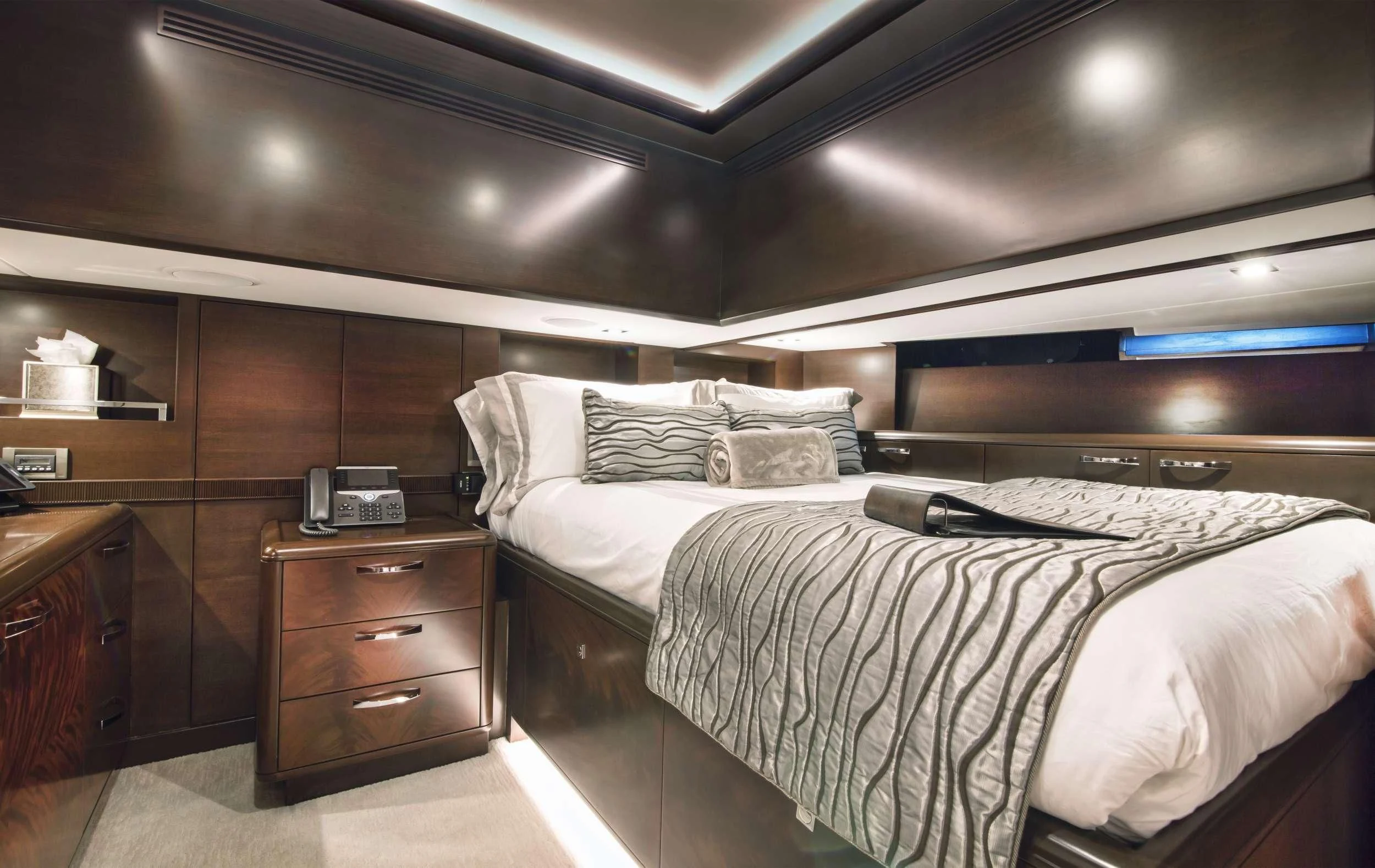 a bed with a white sheet and a white pillow on it aboard VIVIERAE II Yacht for Sale