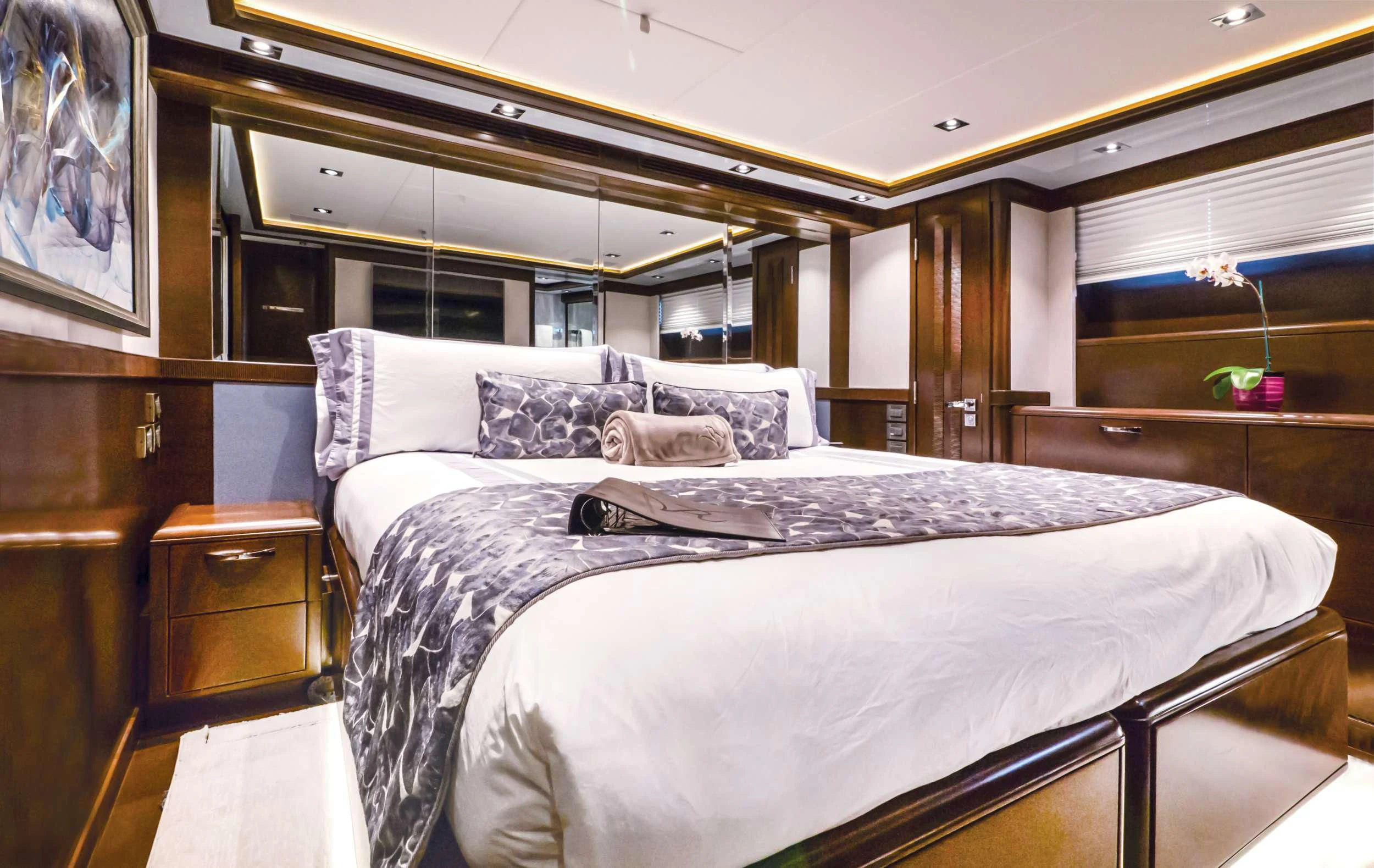 a bed with a white sheet and pillows aboard VIVIERAE II Yacht for Sale