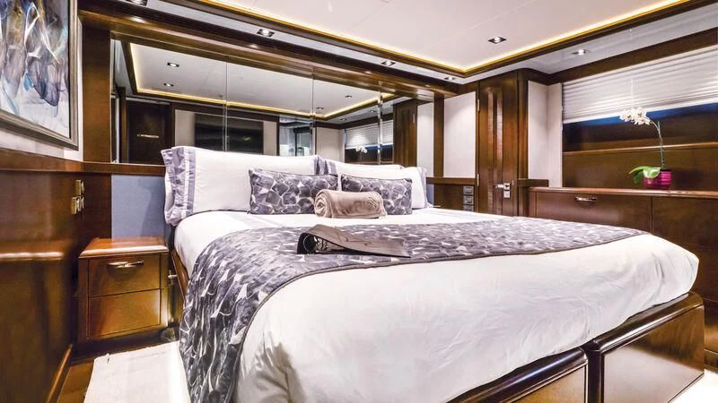 a bedroom with a large bed aboard VIVIERAE II Yacht for Sale
