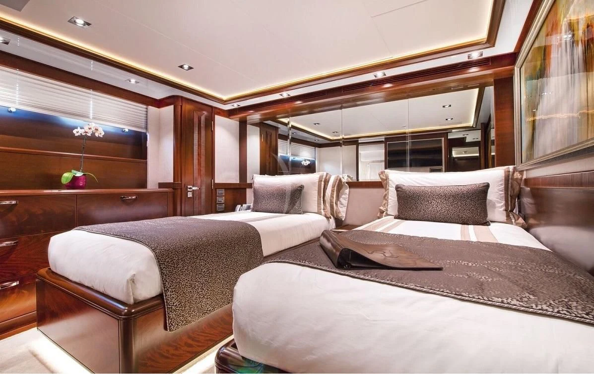 a room with a bed and a couch aboard VIVIERAE II Yacht for Sale