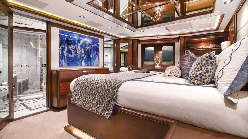 a room with a bed and a mirror aboard VIVIERAE II Yacht for Sale