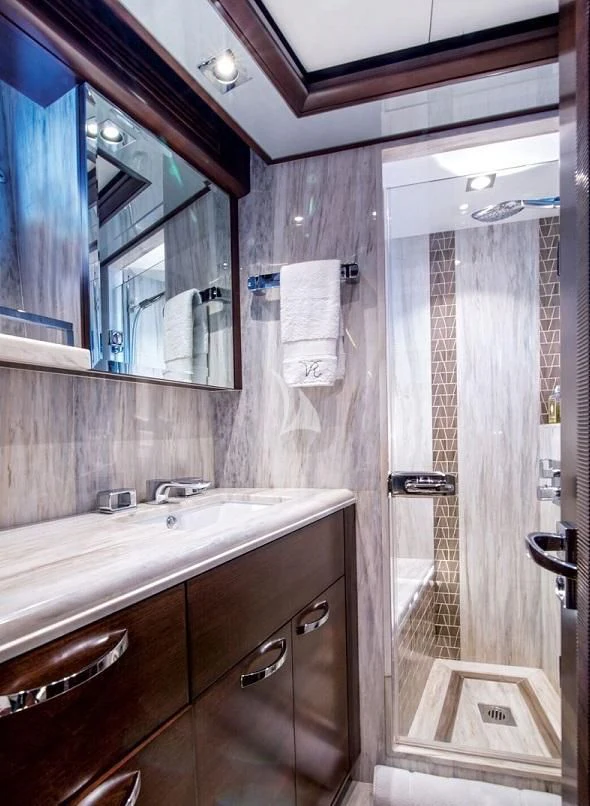a bathroom with a shower and sink aboard VIVIERAE II Yacht for Sale