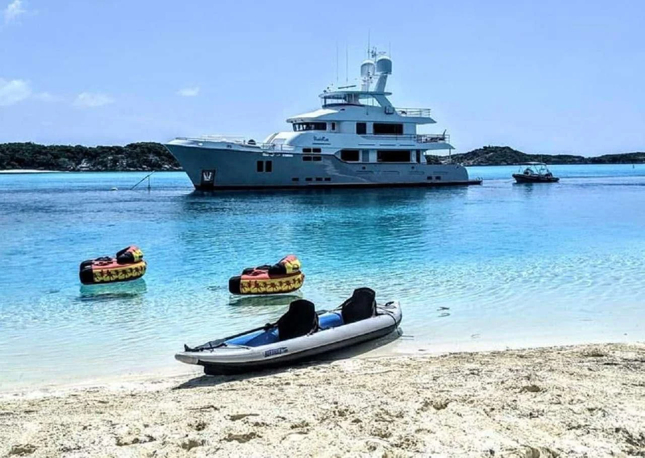 a boat and a boat on a beach aboard VIVIERAE II Yacht for Sale