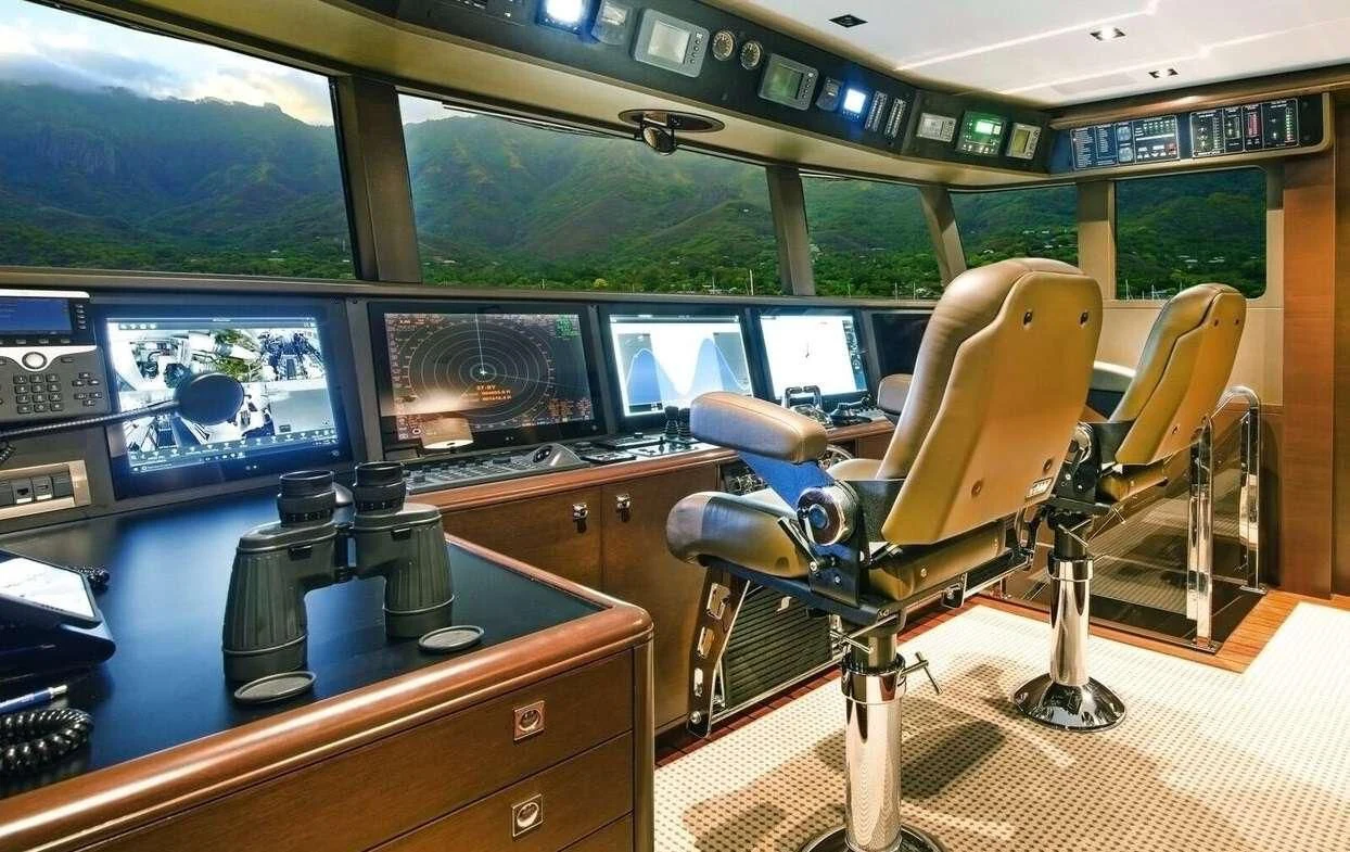 a room with a desk and chairs aboard VIVIERAE II Yacht for Sale