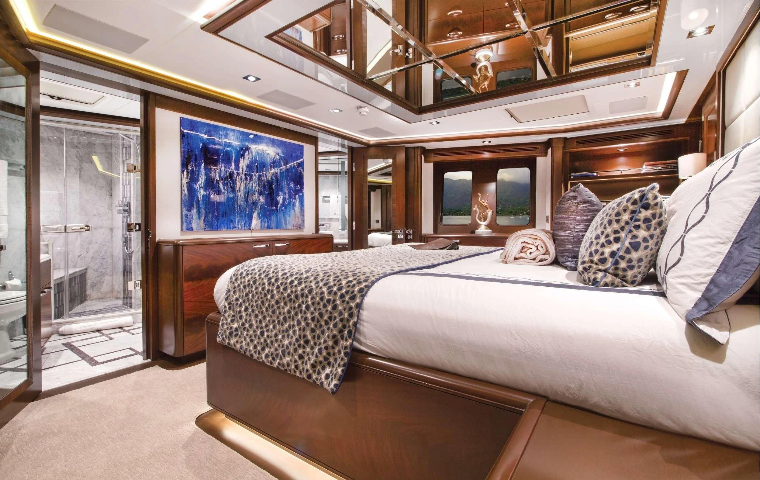a room with a bed and a mirror aboard VIVIERAE II Yacht for Sale