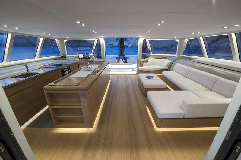 a room with a wood floor and a wood table with white couches aboard ALLEGRA Yacht for Sale
