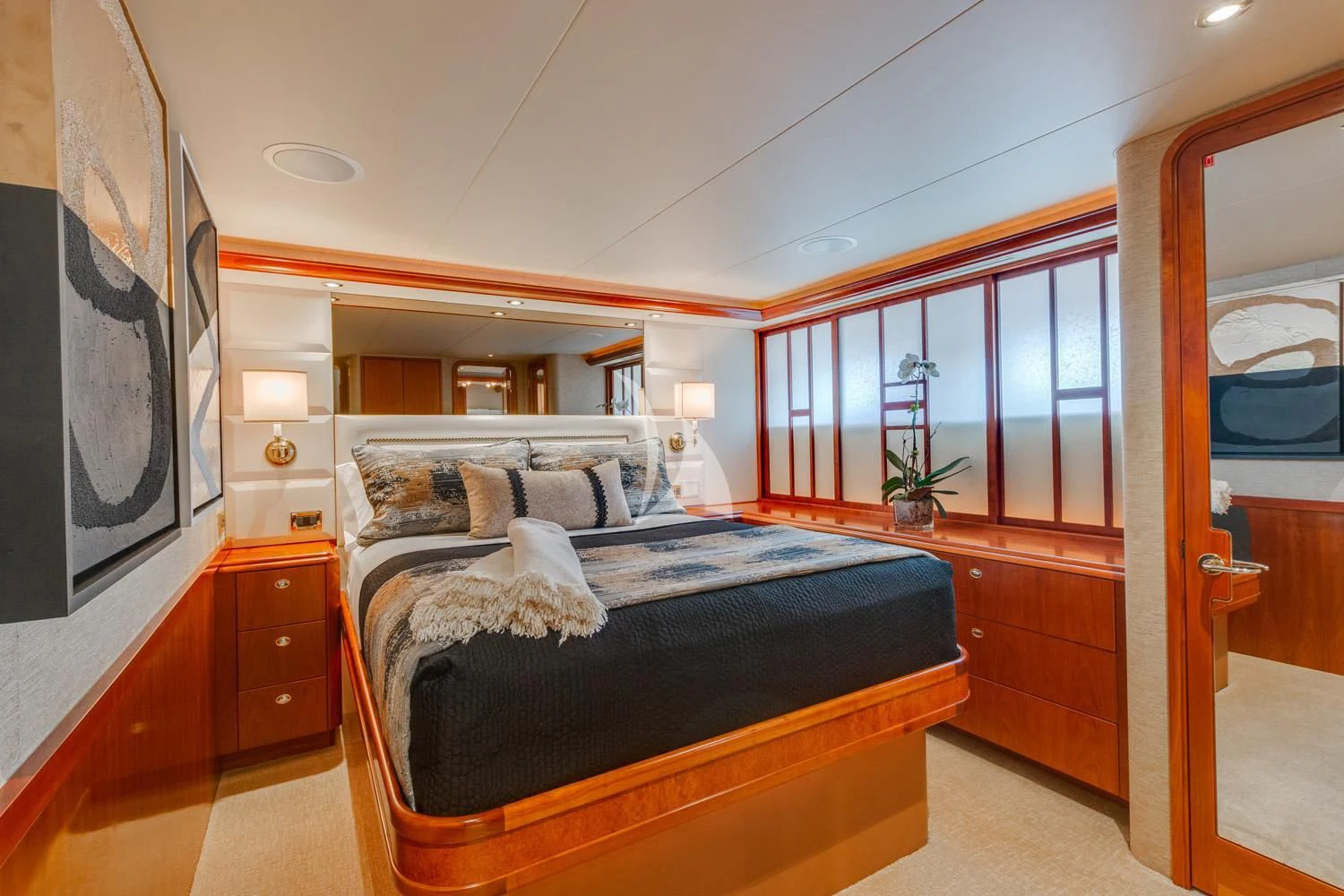 a bedroom with a bed and a painting on the wall aboard MY WAY Yacht for Sale