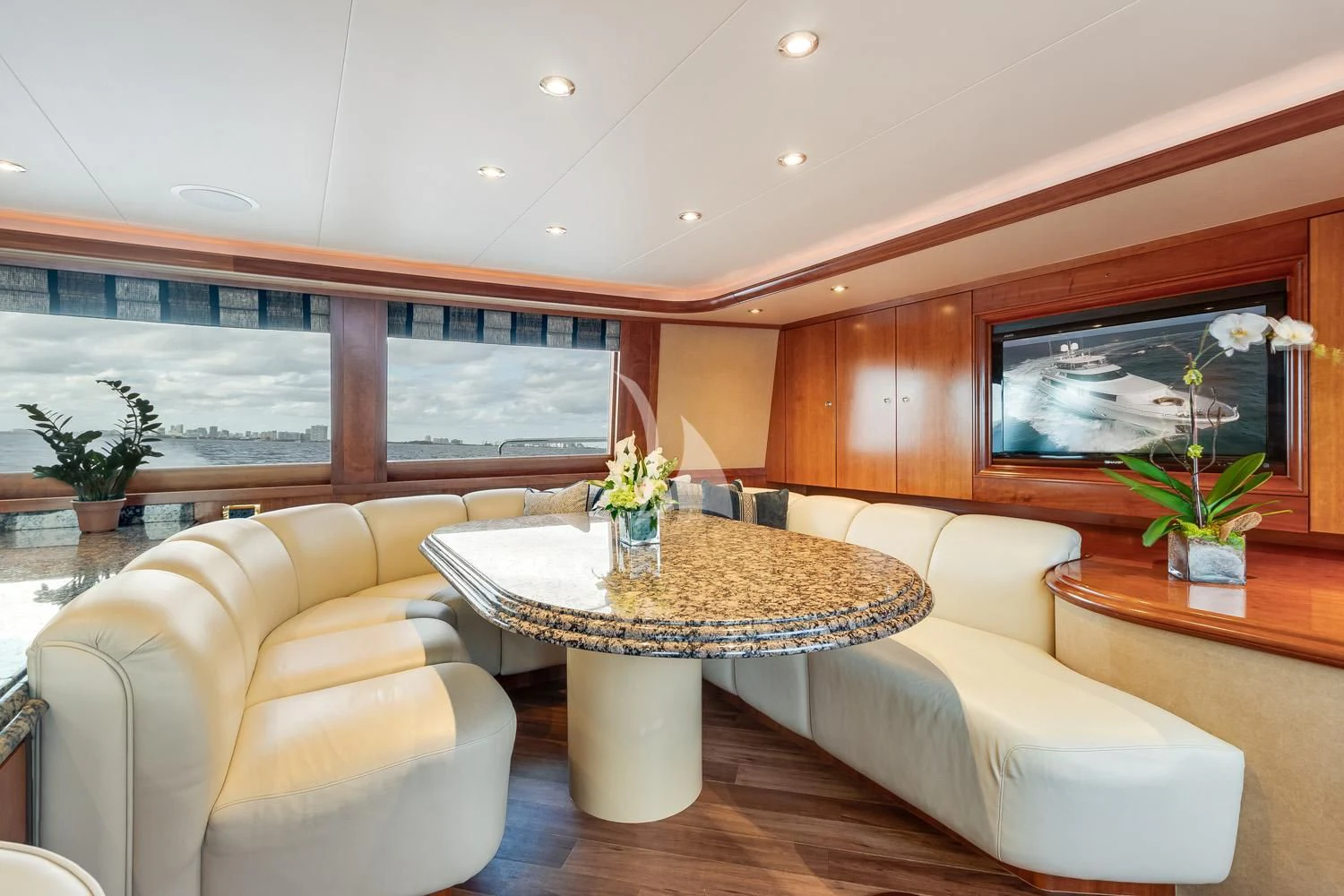 a living room with a table and couches aboard MY WAY Yacht for Sale