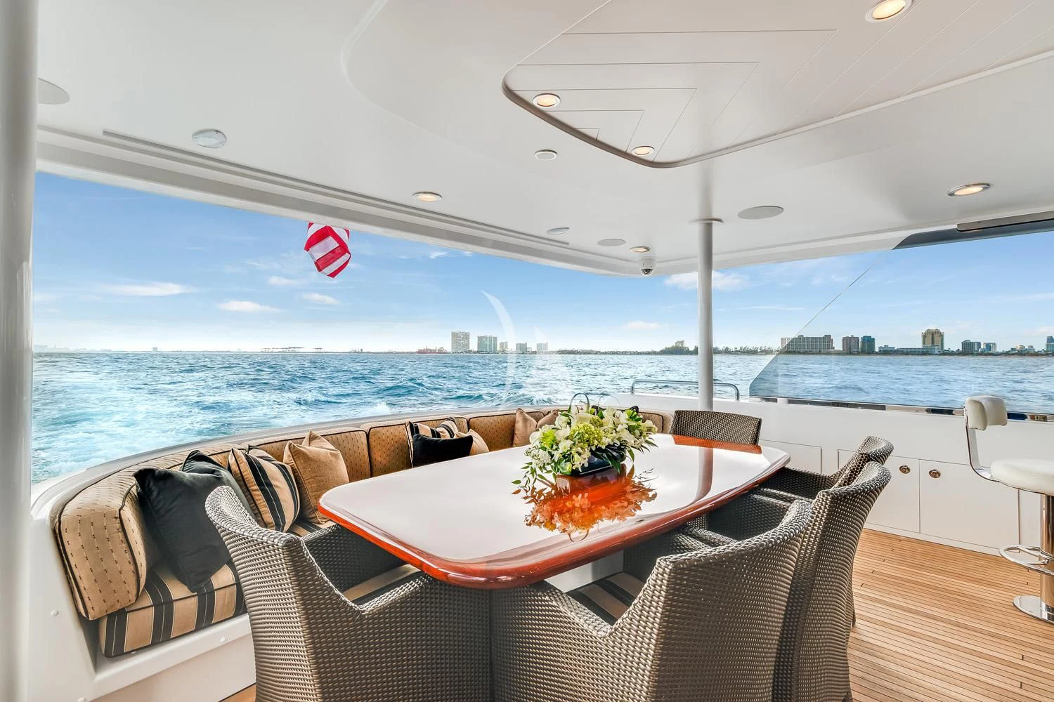 a table with chairs on it next to a large body of water aboard MY WAY Yacht for Sale